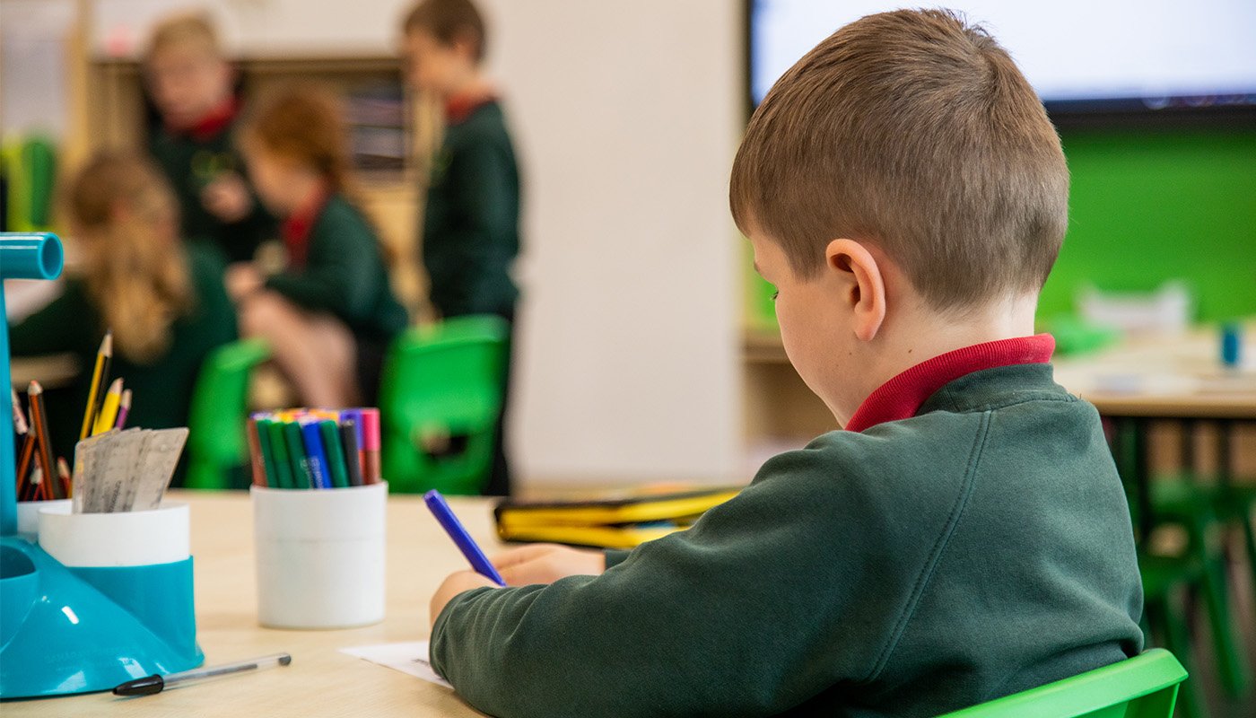 A young pupil colouring in