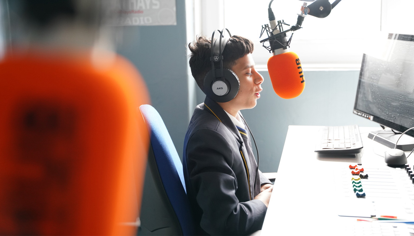 A pupil talking into a microphone