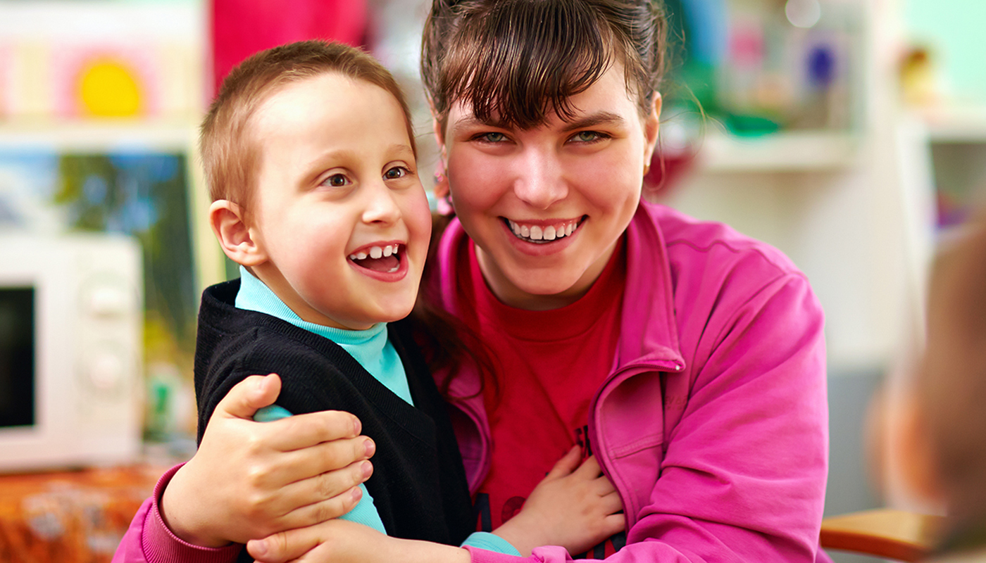 A pupil with a staff member