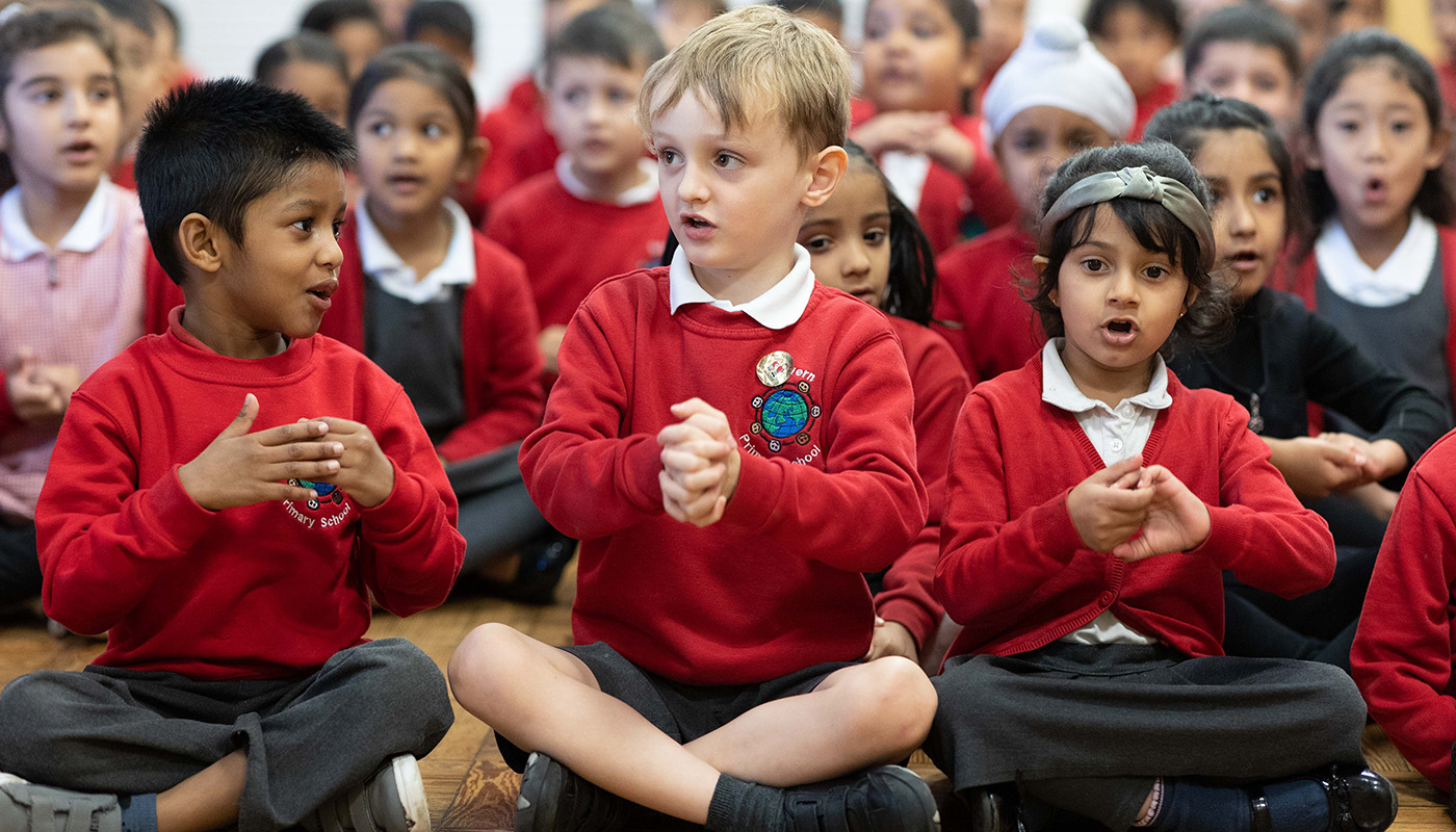 Children sitting on the floor in a school