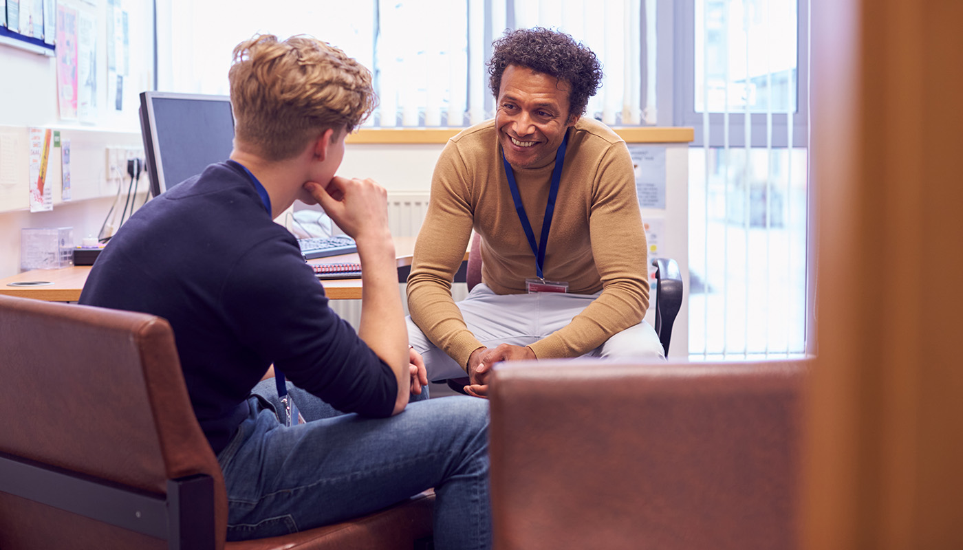 Two people sitting down and talking