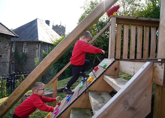 Children climbing on some outdoor equipment 