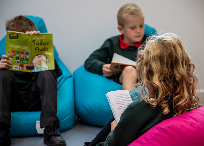 School children reading Welsh language books