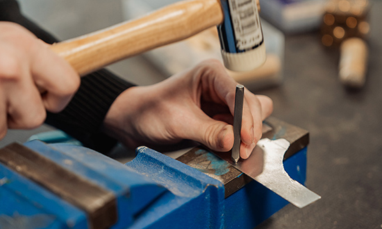 A close-up of a person doing metalwork