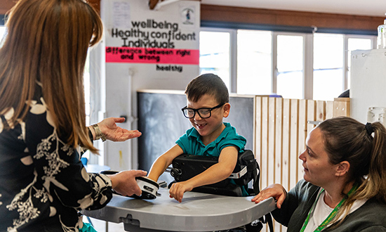Young boy smiling with adults